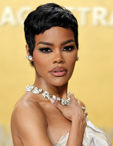 Teyana Taylor posing in a strapless dress and diamond necklace