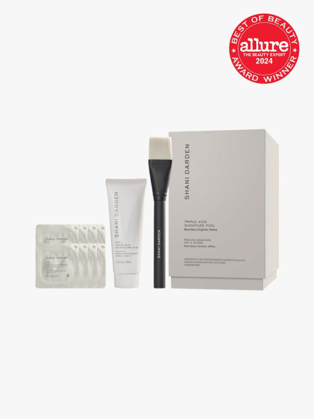 facial peel system with brush applicator product and additional sachets next to branded box packaging on light gray background with red and white 2024 allure best of beauty seal
